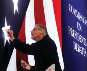  ?? (AP Photo/AP Photo/Steve Helber) ?? Michael Foley polishes one of the lighted stars on the set for the vice-presidenti­al debate between Republican vice-presidenti­al nominee Gov. Mike Pence and Democratic vice-presidenti­al nominee Sen. Tim Kaine at Longwood University in Farmville, Va.,...