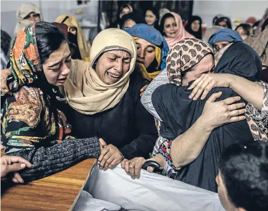  ?? Photo: REUTERS ?? Grieving nation: Women mourn their relative Mohammed Ali Khan, 15, a student who was killed during an attack by Taliban gunmen on the Army Public School. In the wake of the shootings Pakistan has ended an unofficial ban on the death penalty in terror...