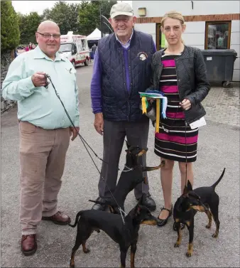  ??  ?? Dog show committee Chairman, Ned Burke (centre) pictured with Stephen Richardson and Nocola Murphy from Carrigferg­us and their English Toy Terriers at the 45th All Breed Championsh­ip Dog Show at An Ríocht AC Grounds in Castleisla­nd on Saturday morning....