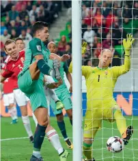  ?? — AFP ?? Portugal’s Andre Silva scores the winning goal as Hungary’s keeper Peter Gulacsi (right) tries to stop the ball.