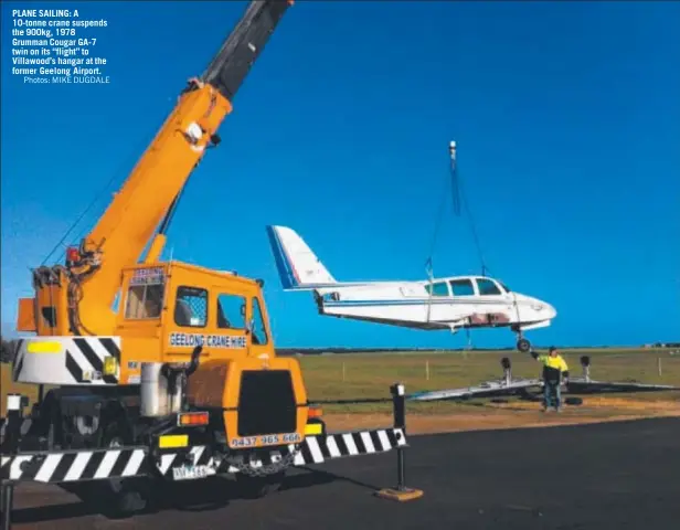  ?? Photos: MIKE DUGDALE ?? PLANE SAILING: A 10-tonne crane suspends the 900kg, 1978 Grumman Cougar GA-7 twin on its ‘‘flight’’ to Villawood’s hangar at the former Geelong Airport.