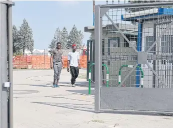  ??  ?? FORGOTTEN: Migrants walk at the Cona reception centre, near Padua. The Italian town’s mayor says they are squashed in together, with no hope for a better future.