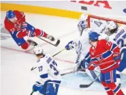  ?? RYAN REMIORZ/THE CANADIAN PRESS VIA AP ?? Montreal Canadiens’ Josh Anderson (17) scores the winning goal against Tampa Bay Lightning’s goaltender Andrei Vasilevski­y during overtime in Monday night’s 3-2 Montreal win.