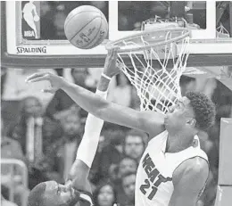  ?? JOHN AMIS/AP ?? Heat center Hassan Whiteside (21) defends the basket against Atlanta Hawks guard Tim Hardaway Jr. during the second half of their game Friday in Atlanta.