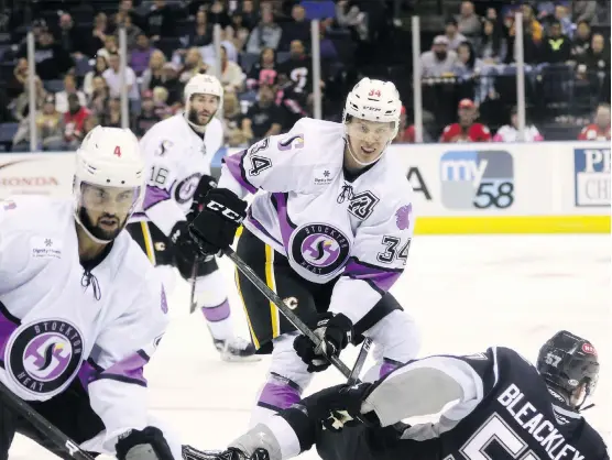  ?? JACK LIMA ?? Stockton Heat defenceman Adam Ollas-Mattsson, centre, sported the “A” on his No. 34 jersey during Stick It To Cancer Night on Saturday. The 22-year-old lost his mother, Elisabeth, to cancer in 2012 and after the game, Ollas-Mattsson’s teammates chipped in to purchase his game-worn jersey during a live auction and gifted it back to him.