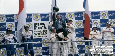  ??  ?? Blundell and Dalmas hold Todt aloft, Warwick tries to wrench his arm