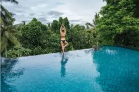  ??  ?? A tourist enjoys an infinity pool at a resort in Ubud, Bali. The Indonesian island’s economy has been devastated by Covid. Photograph: swissmedia­vision/Getty Images