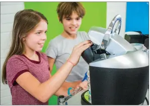  ?? WILLIAM HARVEY/THREE RIVERS EDITION ?? Abby Dockins, 11, left, and Ellieanna Harmon, 10, brew up some morning joe at the Coffee Corner at Central Magnet Elementary School in Batesville. Students use a Keurig coffee maker to serve $1 drinks each school day and raise money to give back to the...