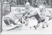  ?? TOMMIHALEK— ASSOCIATED PRESS ?? Nashville goalie Pekka Rinne, left, defends as Anthony Bitetto, right, looks to clear the puck on Thursday.