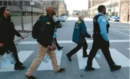  ?? ANTONIO PEREZ/CHICAGO TRIBUNE ?? Chicago police, U.S. Secret Service, FBI and other agencies canvass the area near McCormick Place on Monday to provide informatio­n to businesses and residents about heightened security during this summer’s Democratic National Convention.