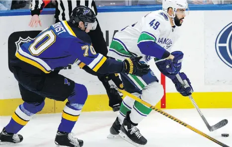  ?? THE ASSOCIATED PRESS ?? Canucks coach Travis Green says Darren Archibald, right, has to play a physical game if he wants to remain in the NHL.