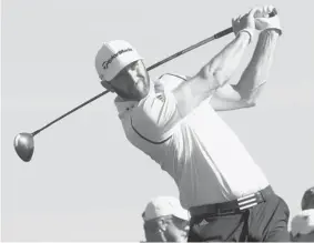  ?? STEPHEN DUNN/Getty Images ?? Dustin Johnson hits a tee shot on the third hole in the first round of the Northern Trust
Open at the Riviera Country Club on Thursday in Pacific Palisades, Calif.