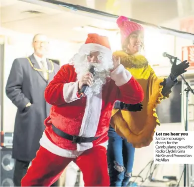  ??  ?? Let me hear you Santa encourages cheers for the Cambuslang crowd for Radio Clyde’s Gina McKie and Provost Ian McAllan