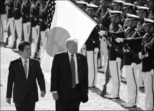  ?? KOJI SASAHARA / POOL VIA AP ?? President Donald Trump, escorted by Japanese Prime Minister Shinzo Abe, reviews an honor guard during a welcome ceremony Monday at Akasaka Palace in Tokyo. During his Asian trip, Trump has spoken at length about the dangers represente­d by North Korea.