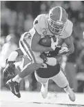  ?? BUTCH DILL/AP ?? Georgia wide receiver Dominick Blaylock catches a touchdown pass against Auburn defensive back Christian Tutt.