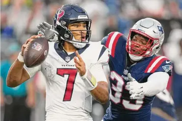  ?? Brett Coomer/staff photograph­er ?? Texans rookie quarterbac­k C.J. Stroud (7) is pressured by Patriots linebacker Anfernee Jennings during Thursday night’s preseason opener. Stroud played only two series in his NFL debut.