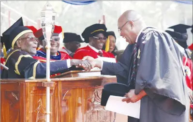  ??  ?? President Mugabe caps Chief Ephias Munodawafa (Chief Murinye), who graduated with a Bachelor of Law degree at the University of Zimbabwe, yesterday. — (See story on Page 2 and more pictures on Page 6). — (Picture by John Manzongo)