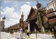  ?? Associated Press ?? Tourists visit Grand Palace in Bangkok, Thailand, on June 17.