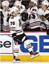  ?? AP ?? Rookie Cole Guttman celebrates with teammates after scoring his first NHL goal in the third period.