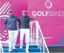  ?? ANDREW REDINGTON/ GETTY IMAGES ?? Alex Levy, left, and Greg Bourdy of France walk to the first tee at Friday's Pro Am at the GolfSixes event.