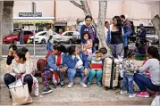  ?? SANDY HUFFAKER / THE NEW YORK TIMES ?? Undocument­ed migrants wait for asylum hearings outside the U.S. port of entry in Tijuana, Mexico, on Tuesday. Many migrants flee persecutio­n and violence in their home countries.