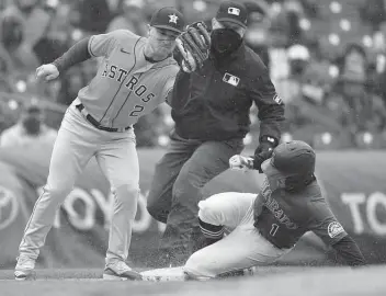  ?? David Zalubowski / Associated Press ?? Colorado’s Garrett Hampson steals third ahead of Martin Maldonado’s throw to Alex Bregman.