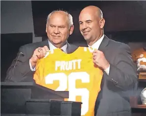  ?? STEVE MEGARGEE/ AP ?? Tennessee football coach Jeremy Pruitt, right, received a personaliz­ed jersey from athletic director Phillip Fulmer during his introducto­ry news conference in 2017. Neither will be with the school next season.
