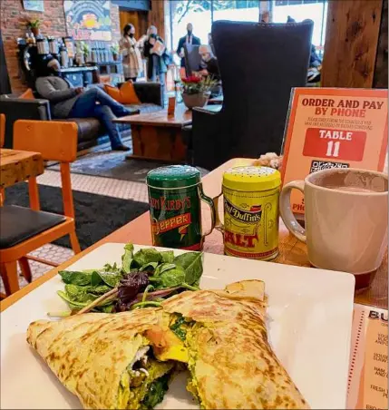  ?? Photos by Susie Davidson Powell / For the Times Union ?? The Breakfast Monster crepe features cage-free eggs, wilted spinach, caramelize­d onions, roasted squash tossed with pesto and Cabot cheddar.