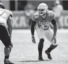  ?? Getty Images / Getty Images ?? Texas’ David Gbenda, who endured a forgettabl­e cameo as a backup running back in 2019, is more comfortabl­e on the defensive side of the ball.