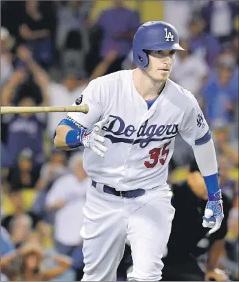  ?? Mark J. Terrill Associated Press By Jack Harris ?? CODY BELLINGER tosses his bat after hitting his 45th home run of the season, a solo shot that gave the Dodgers a 6-4 lead. Dodgers closer Kenley Jansen would give up the tying runs in top of the ninth inning.