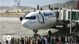  ??  ?? Afghan people climb atop a plane as they wait at the Kabul airport in Kabul