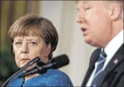  ?? EVAN VUCCI / ASSOCIATED PRESS ?? German Chancellor Angela Merkel listens as President Donald Trump speaks during their joint news conference in the East Room of the White House in Washington on Friday.