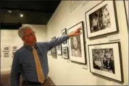  ?? Online: Photos and a video of the exhibit can be seen with this story at DAILYFREEM­AN.COM ?? Herman Eberhardt, the curator at the Franklin D. Roosevelt Presidenti­al Museum in Hyde Park, N.Y., points to a photo taken of a Japanese American enlisted soldier who is showing his interned brother his Purple Heart medal.