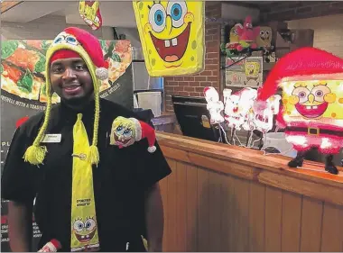  ?? | PHOTOS BY JERRY DAVICH ?? Rufus Cross of Gary uses his favorite fictional character, SpongeBob SquarePant­s, to touch the hearts of his customers at Pizza Hut in Griffith.