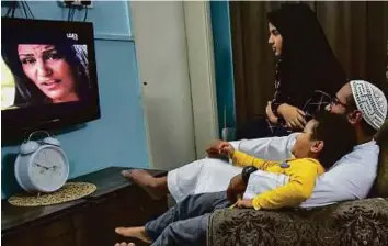  ?? Ahmed Ramzan/Gulf News ?? A family watches TV at home in Sharjah. The UAE has 16 terrestria­l channels, of which 13 are stateowned, says Arab Media Outlook Report 2016, adding Pay TV is the key driver of TV growth.