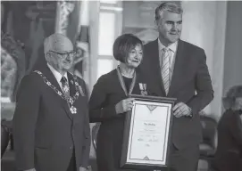  ?? RYAN TAPLIN/SALTWIRE NETWORK ?? Ann MacLean poses for a photo with Lt.-Gov. Arthur LeBlanc, left, and Premier Stephen McNeil during the Order of Nova Scotia ceremony at Province House on Nov. 26. MacLean, the former mayor of New Glasgow, has also worked as a mental health therapist, social worker and addictions treatment supervisor among many other roles.
