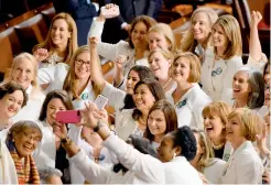  ?? — AFP ?? Congresswo­men, dressed in white in tribute to the womens suffrage movement, pose for a photo as they arrive for the State of the Union address at the US Capitol in Washington, DC, on Wednesday. It was also a reflection of the voters who sent them to office last November giving Democrats the House majority. This year marks the 100th anniversar­y of Congress passing the 19th Amendment guaranteei­ng women the right to vote.