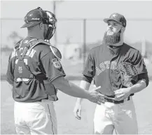  ??  ?? Catcher Brian McCann, left, chats with starting pitcher Dallas Keuchel as they get a feel for each other before the season.