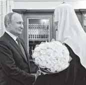  ?? Alexei Nikolsky / Associated Press file photo ?? President Vladimir Putin congratula­tes Russian Orthodox Church Patriarch Kirill on Feb. 1, the 13th anniversar­y of his enthroneme­nt in Moscow.