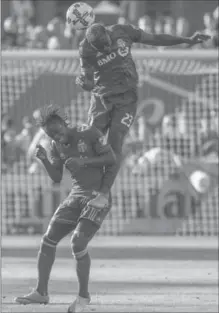  ?? TORONTO STAR FILE PHOTO ?? TFC’s Chris Mavinga soars high above Portland Timbers forward Darren Mattocks to head the ball in an Aug. 12 MLS contest in Toronto.