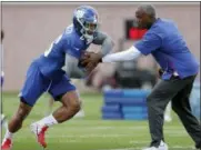  ?? JULIO CORTEZ — THE ASSOCIATED PRESS ?? New York Giants running back Saquon Barkley, left, takes a handoff during a drill at NFL football training camp, Thursday in East Rutherford, N.J.