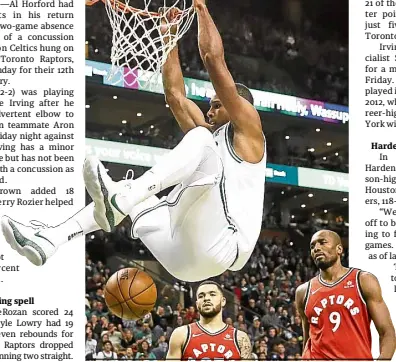  ?? —AP ?? Boston’s Al Horford hangs from the rim as Toronto’s Fred VanVleet and Serge Ibaka (9) could only look on.