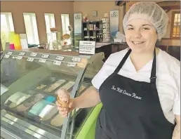  ?? "4)-&: 5)0.140/ ?? Fox Hill Cheese House employee Alyssa Macdonald gets ready to enjoy a cone of the Port Williams-based store’s popular gelato.