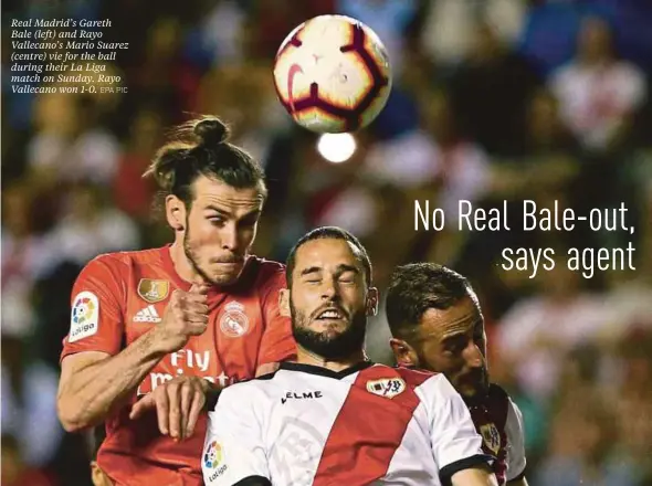  ?? EPA PIC ?? Real Madrid’s Gareth Bale (left) and Rayo Vallecano’s Mario Suarez (centre) vie for the ball during their La Liga match on Sunday. Rayo Vallecano won 1-0.