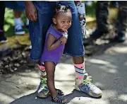  ??  ?? Neflian Canales waits in line for the arrival of Monica Puig and Maria Sharapova in Loiza, Puerto Rico.