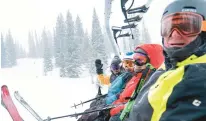  ?? ?? Wild old Bunch members Jimmy Glovaste, from left, Dave Wahlstrom, Anne Kronawitte­r and Greg Brian sit on a ski lift at the Alta Ski Area.