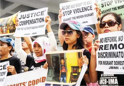  ??  ?? Protesters from Indonesian migrant worker organizati­ons demonstrat­e outside the High Court at the beginning of the trial of British banker Rurik Jutting, 31, accused of the murders of two Indonesian women, in Hong Kong on Monday. (AFP)