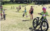  ??  ?? Coming through . . . Year 3 runners and cyclists compete for space on the slope in the Puzzling World Junior Challenge Wanaka at Glendhu Bay yesterday morning.