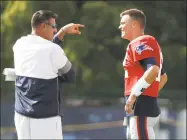  ?? Mark Humphrey / Associated Press ?? Tennessee Titans head coach Mike Vrabel talks with New England Patriots quarterbac­k Tom Brady during a combined NFL training camp Wednesday in Nashville, Tenn. Vrabel and Brady were teammates when Vrabel played for the Patriots.