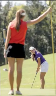  ?? Arkansas Democrat- Gazette/ BENJAMIN KRAIN ?? Bailey Dunstan ( back) of Baptist Prep chips onto the green while Lilly Thomas of Heber Springs holds on to the fl ag stick during the Class 4A girls state golf tournament at Maumelle Country Club on Tuesday. Dunstan shot a 3- over 76 Tuesday, fi...